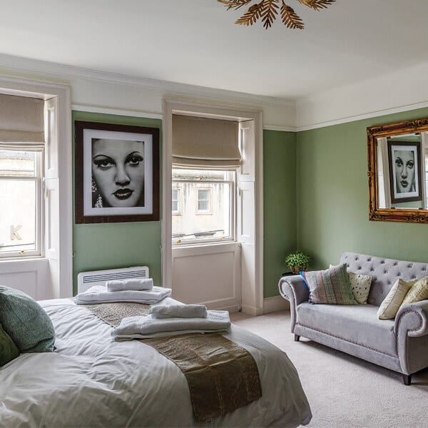 A green-walled double bedroom